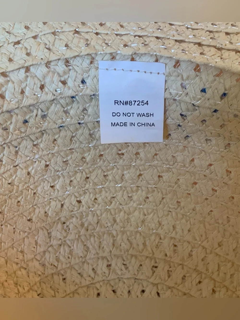 Tan straw hat with blue/white striped ribbon